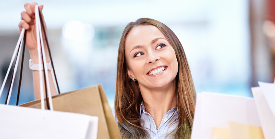 Happy customer holding shopping bags